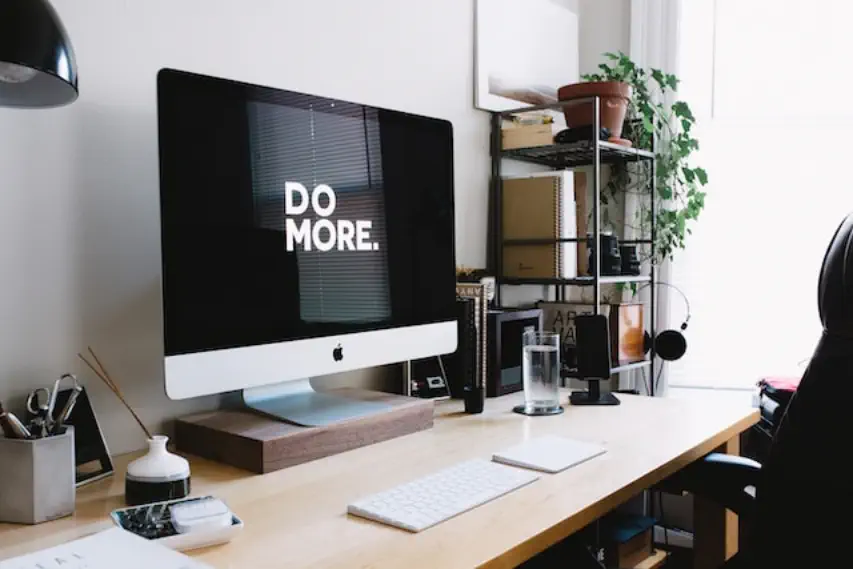 Home office area during the day with a computer monitor on a desk with the words, Do More